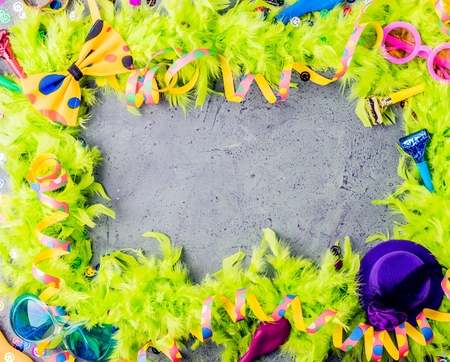 Colorful birthday or carnival frame with party items on stone backgroundの写真素材