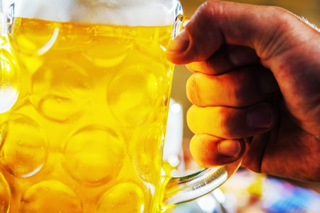 Oktoberfest beer, pretzels and various Bavarian specialties on wooden backgroundの写真素材