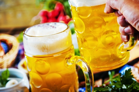 Oktoberfest beer, pretzels and various Bavarian specialties on wooden backgroundの写真素材