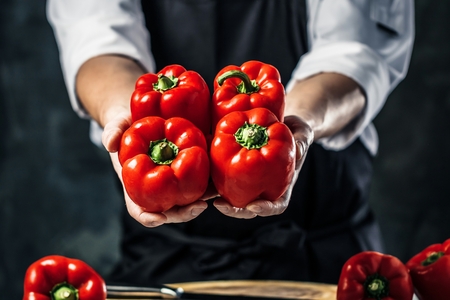 Chef cook preparing vegetables in his kitchen.