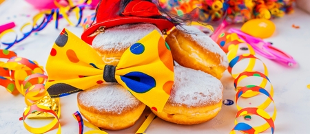Carnival powdered sugar donuts with paper streamersの写真素材