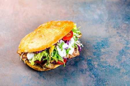 Delicious kebab sandwich on wooden backgroundの写真素材