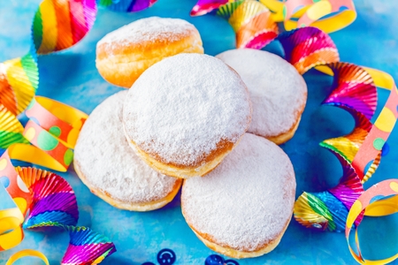 Carnival powdered sugar donuts with paper streamersの写真素材