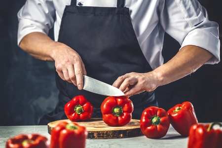 Chef cook preparing vegetables in his kitchen.の写真素材