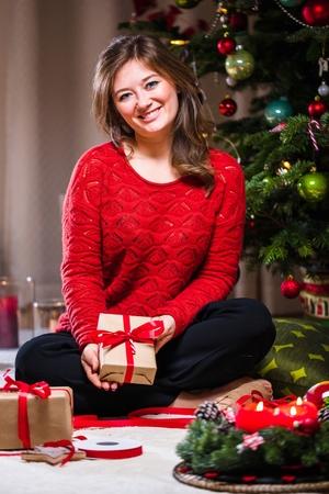 Woman Wrapping and Decorating Christmas Presentの写真素材