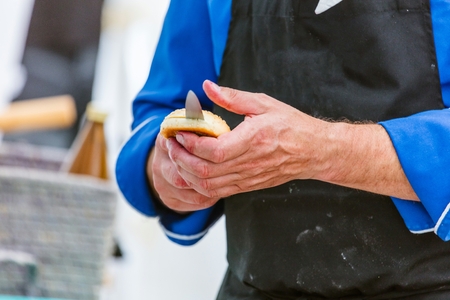 Chef cutting fresh bread for Burgerの写真素材