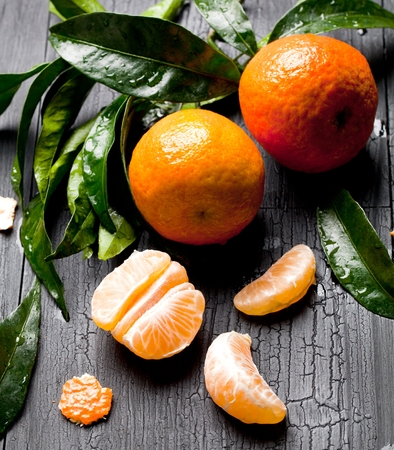 Fresh picked mandarins in old metal basketの写真素材
