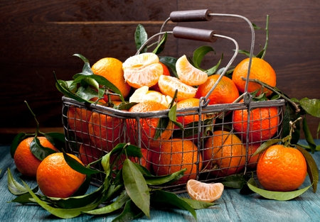 Fresh picked mandarins in old metal basketの写真素材