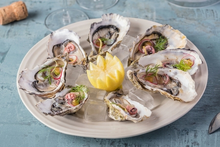 beautiful appetizer oysters and glasses champagne on Festive Table