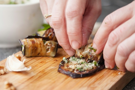 Tasty eggplant rolls stuffed with cottage cheese.の写真素材