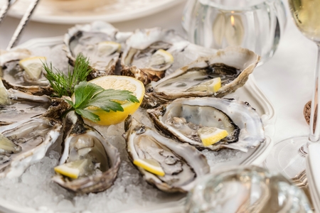 beautiful appetizer oysters two glasses wine champagne.の写真素材