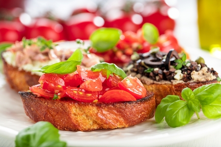 bruschetta, on slices of toasted baguette garnished with basilの写真素材
