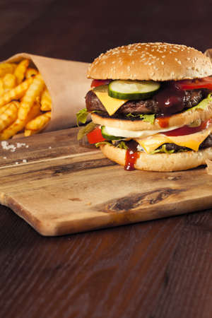 Fast food hamburger and french fries on a wooden Backgroundの写真素材