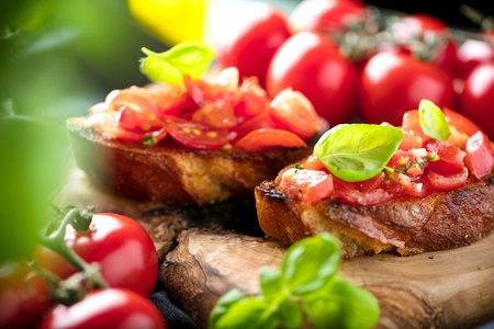 bruschetta, on slices of toasted baguette garnished with basilの写真素材