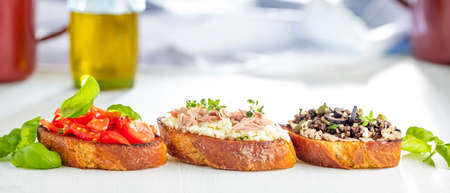 bruschetta, on slices of toasted baguette garnished with basilの写真素材