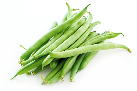 Green beans on wooden cutting board isolated on white vegetarian food