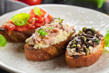 bruschetta, on slices of toasted baguette garnished with basil