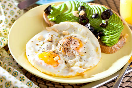 Fried egg. Close up view of the fried egg on a frying pan. Salted and spiced fried egg with parsley...