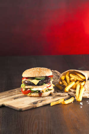 Fast food hamburger and french fries on a wooden Backgroundの写真素材