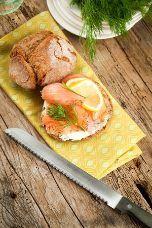 bread with fresh salmon fillet isolated on wooden backgroundの写真素材