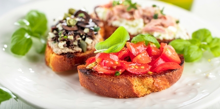 bruschetta, on slices of toasted baguette garnished with basilの写真素材
