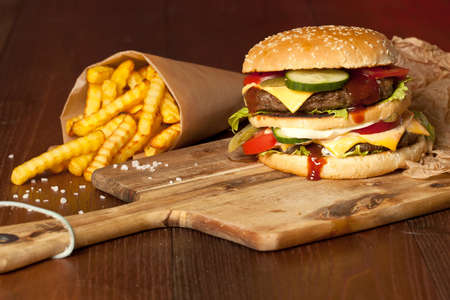 Fast food hamburger and french fries on a wooden Backgroundの写真素材