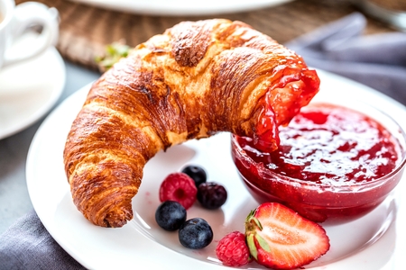 Breakfast served with coffee, orange juice and croissantsの写真素材