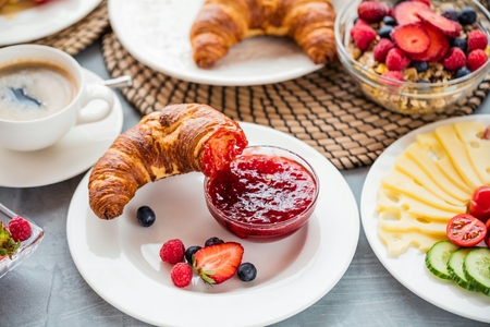 Breakfast served with coffee, orange juice and croissantsの写真素材