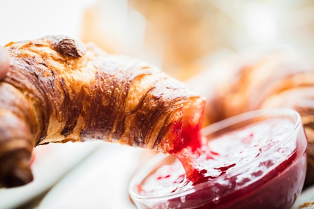 Breakfast served with coffee, orange juice and croissantsの写真素材