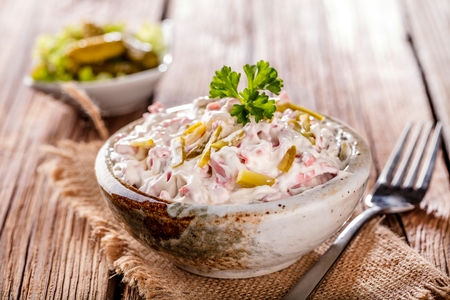 Swabian sausage salad - Elsasser Wurstsalat on wooden backgroundの写真素材