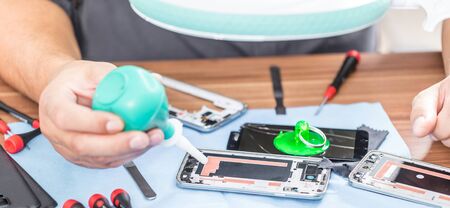 Close-up photos showing process of mobile phone repairの写真素材