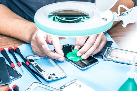 Close-up photos showing process of mobile phone repairの写真素材