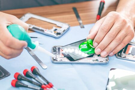 Close-up photos showing process of mobile phone repairの写真素材
