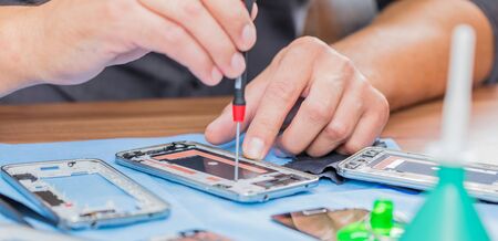 Close-up photos showing process of mobile phone repairの写真素材