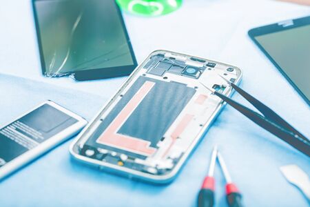 Close-up photos showing process of mobile phone repairの写真素材