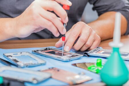 Close-up photos showing process of mobile phone repairの写真素材