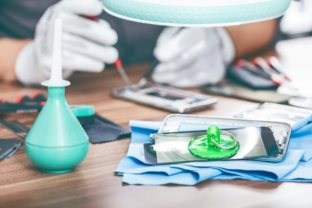 Close-up photos showing process of mobile phone repair