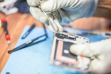 Close-up photos showing process of mobile phone repair