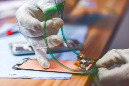 Close-up photos showing process of mobile phone repairの写真素材