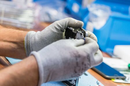 Close-up photos showing process of mobile phone repairの写真素材