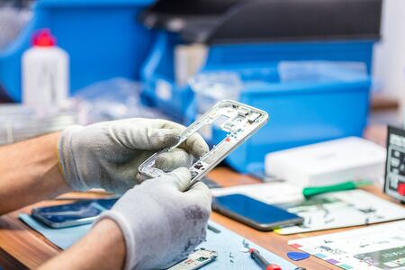Close-up photos showing process of mobile phone repairの写真素材
