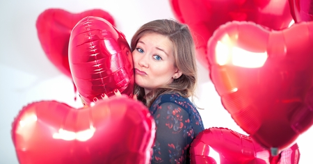Portrait of cute Women with balloons heart Valentinsdayの写真素材