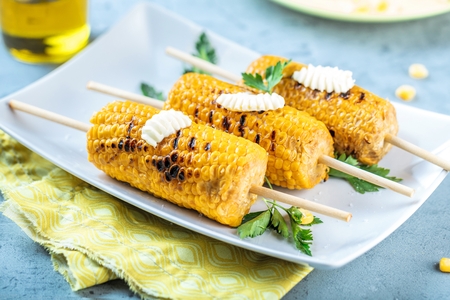Delicious grilled corn on wooden background closeupの写真素材