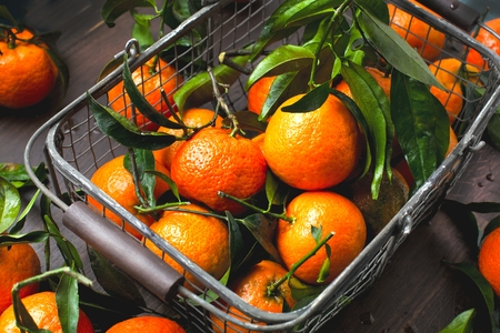 Fresh picked mandarins on wooden background closeupの写真素材