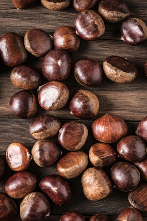 Chestnuts on wooden background closeup cristmas foodの写真素材