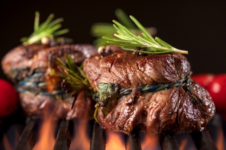 Fresh fillet steak on Grill with flammesの写真素材
