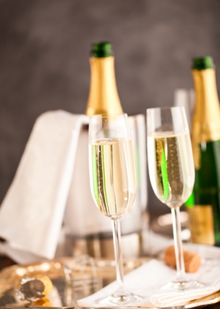 champagne glasses and bottle on dark backgroundの写真素材