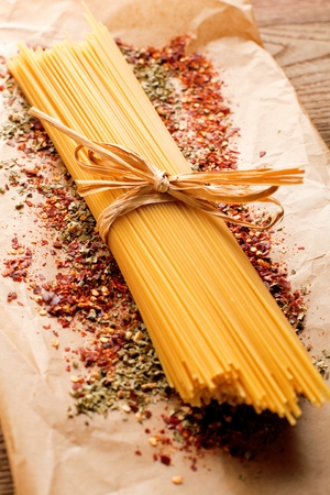 yellow long spaghetti on a rustic background. Yellow italian pasta. Long spaghettiの写真素材
