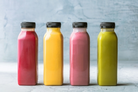 Healthy smoothies with fresh ingredients on a kitchen board.の写真素材