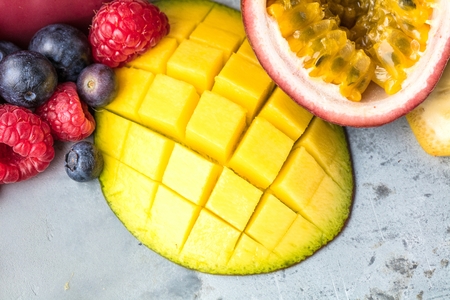 Healthy smoothies with fresh ingredients on a kitchen board.